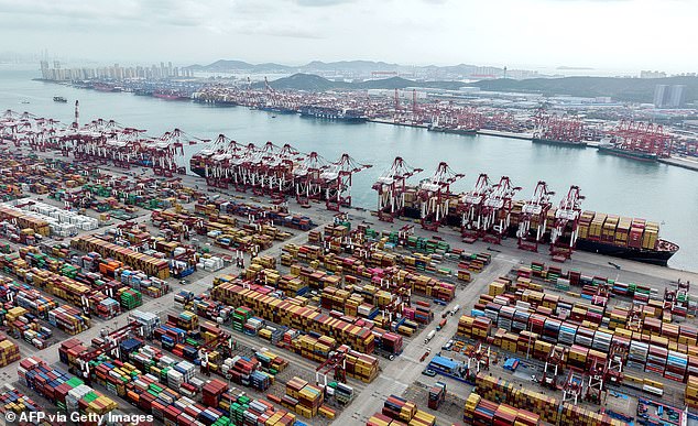 Ships are berthed at the container terminal of the port in Qingdao, in China's eastern Shandong province on October 9, 2025. President Trump announced an additional 100 percent tariff on China on October 10 and threatened to cancel a summit with Xi Jinping, reigniting his trade war with Beijing in a row over export curbs on rare earth minerals.