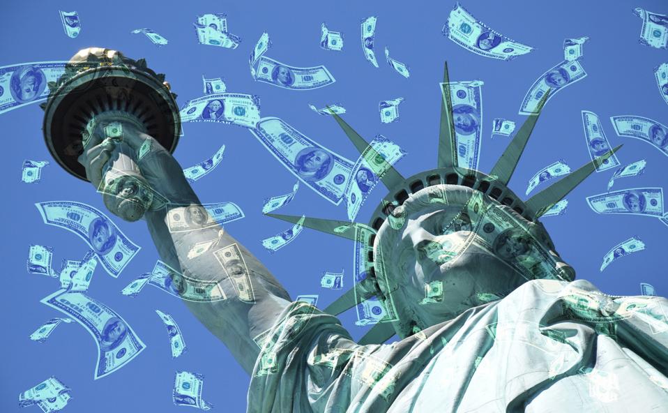 Statue of Liberty with US currency floating in the sky