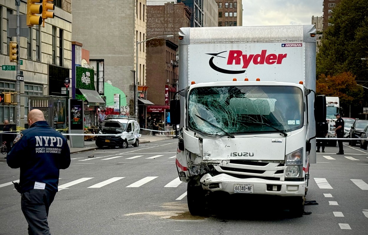 NYPD officers and emergency crews at the scene of Monday’s crash near 8th Avenue and W30th Street