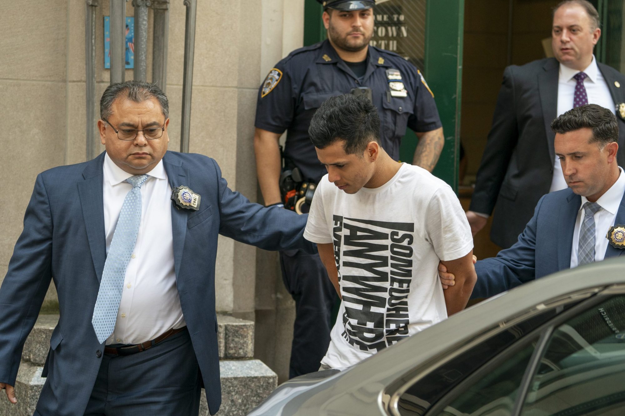 Luis Gil, 19, is walked from the Midtown North precinct Friday, July 28, 2023 in Manhattan, New York. Gil is charged with murder of Hugo Morales. 