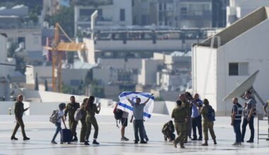 Nimrod Cohen, an Israeli hostage released from the Gaza Strip, holds an Israeli flag after coming off a helicopter at the Ichilov Hospital, in Tel Aviv, Israel, Monday, Oct. 13, 2025. (AP Photo/Ohad Zwigenberg)