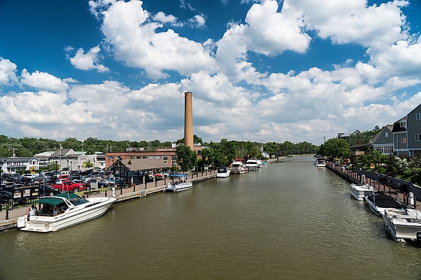 Erie canal with boats and buildings on a summer day in Fairport, New York.