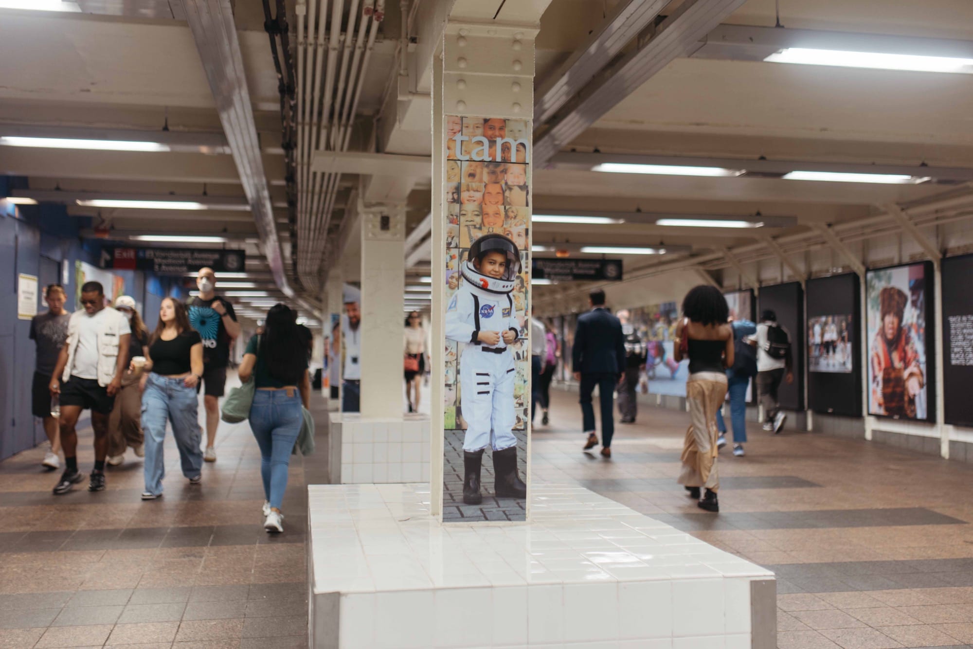 a photo installation of Brandon Stanton's Dear New York in the subway