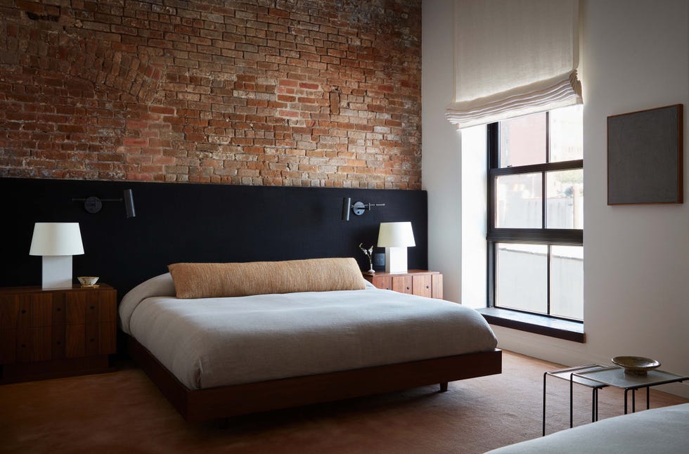 bedroom with brick wall