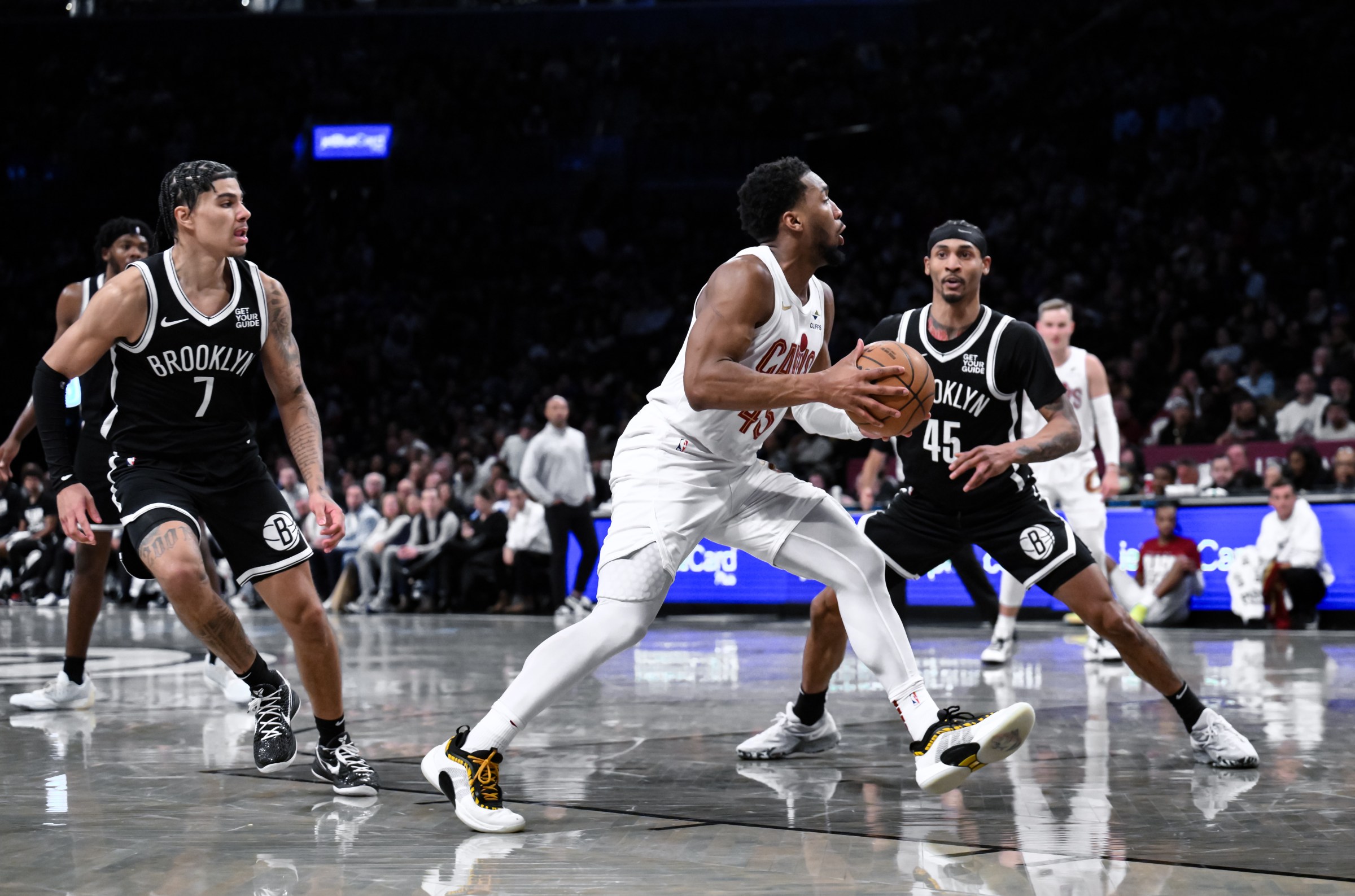 Feb 20, 2025; Brooklyn, New York, USA; Cleveland Cavaliers guard Donovan Mitchell (45) drives to the basket while being defended by Brooklyn Nets guard Keon Johnson (45) during the second half at Barclays Center. Mandatory Credit: John Jones-Imagn Images