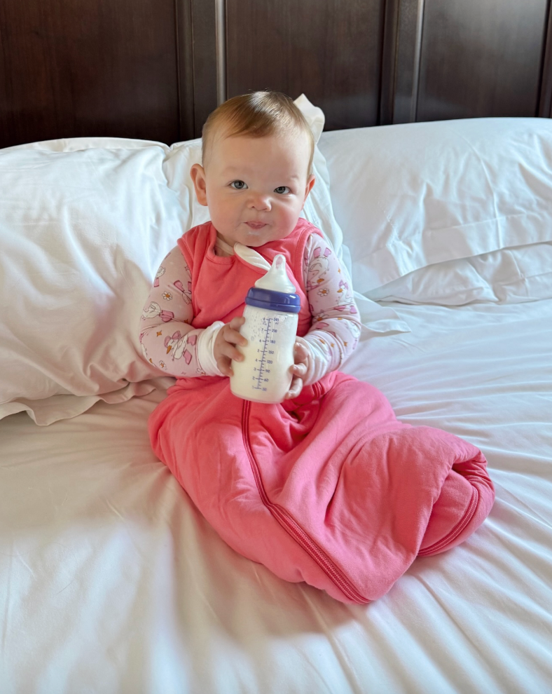 sofia drinking her bottle in bed