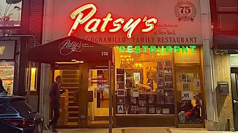 Close-up of Patsy's exterior at night with the restaurant name emblazoned in neon