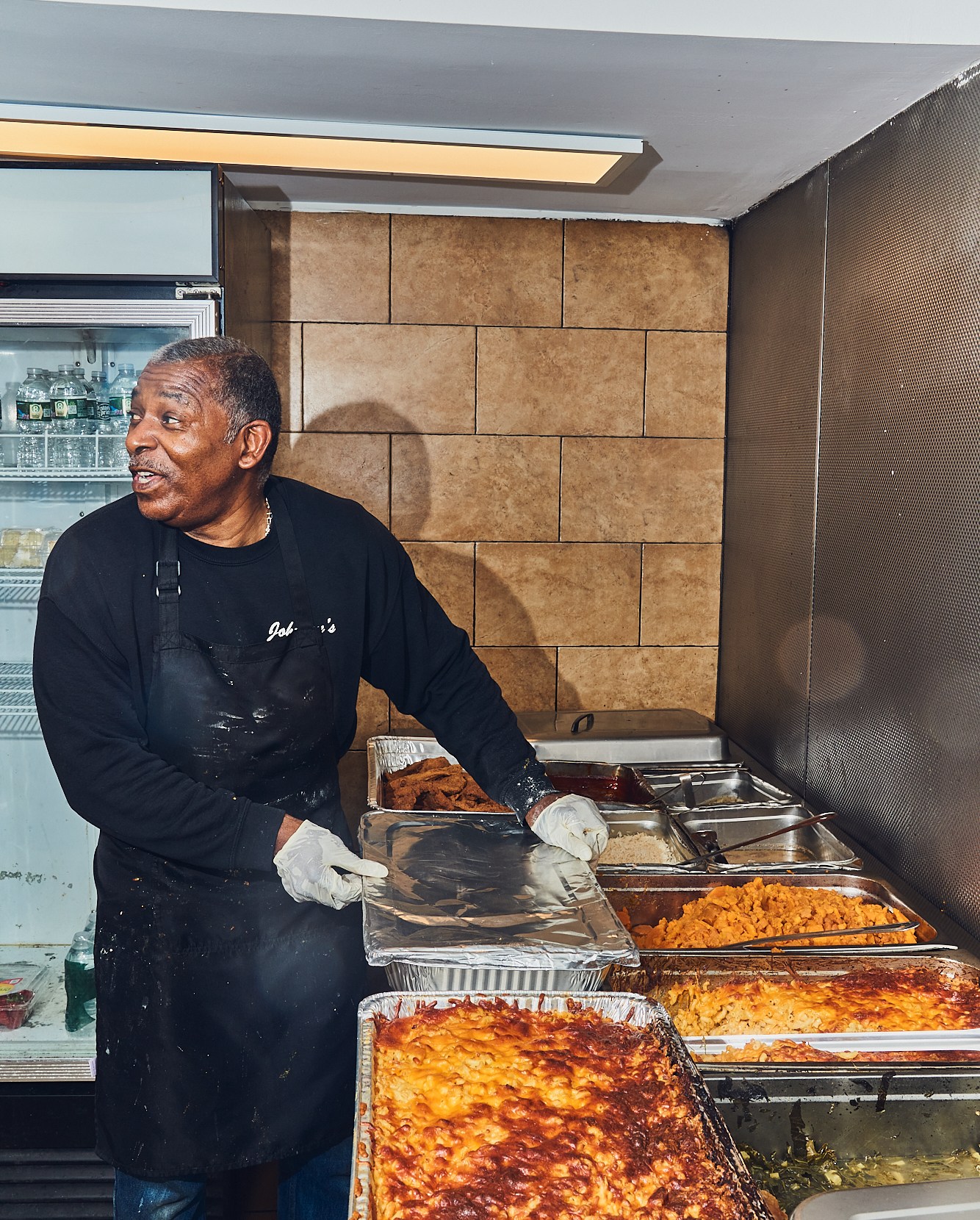 Dwayne Johnson at the buffet station, packing food.