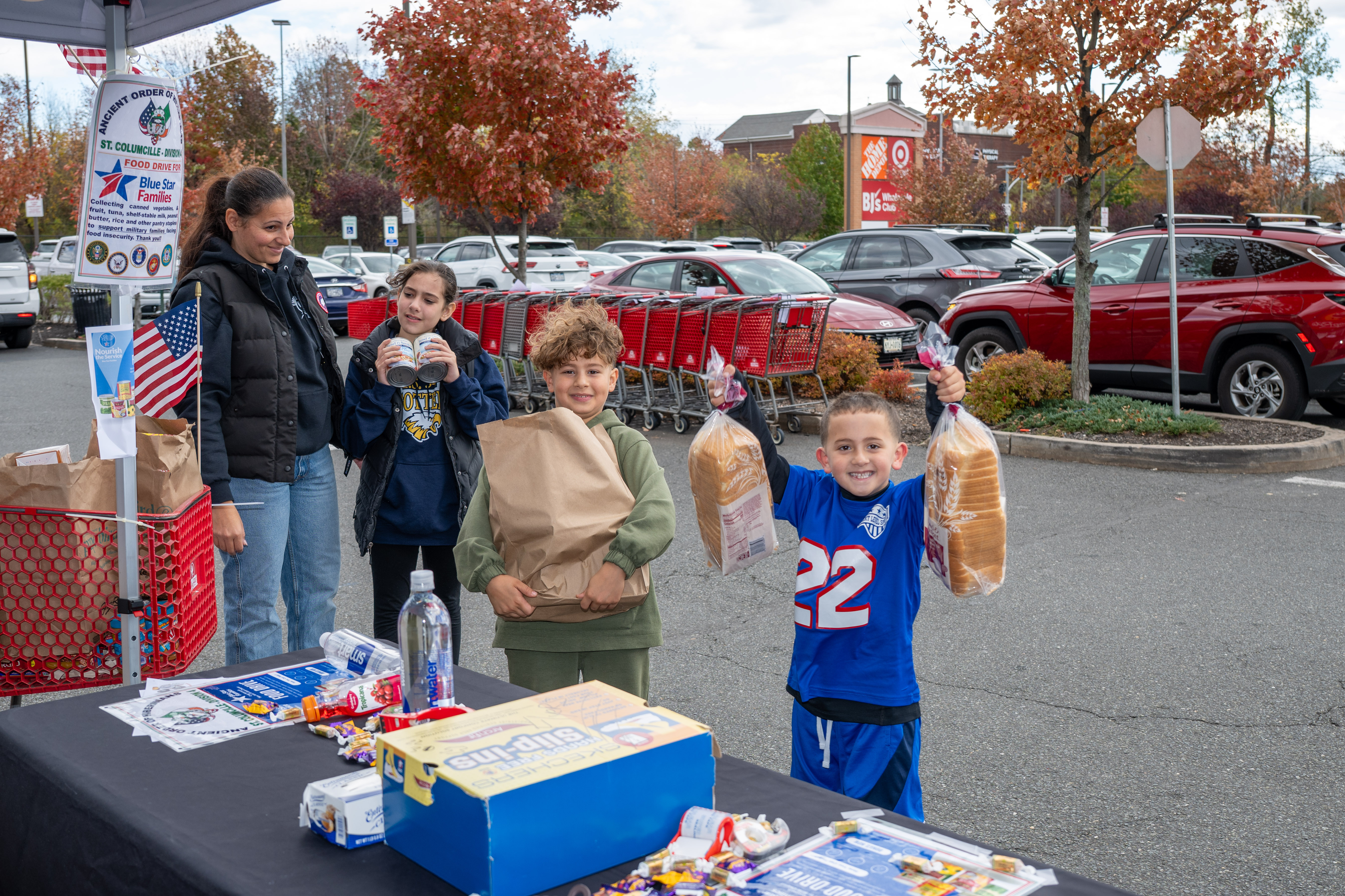 Meramonnie Mongelli and her children, Monroe, 10, Joseph, 7, and Lorenzo, 6, from Tottenville, donate food to the Ancient Order of Hibernians’ food drive for Blue Star Families on Saturday, November 1, 2025, in Charleston. The proceeds will benefit military families at Fort Wadsworth. (Owen Reiter for the Advance/SILive.com)