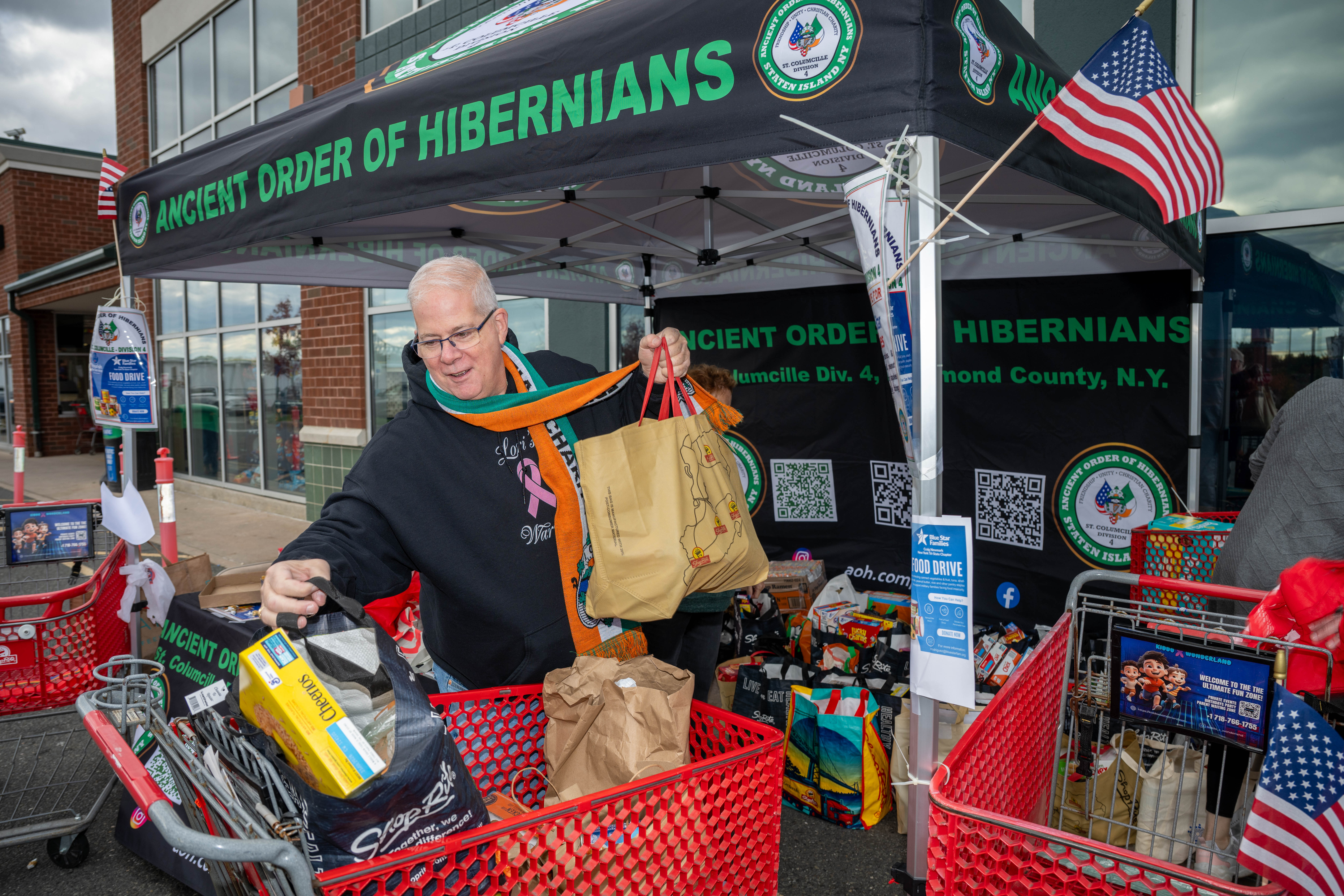 Hundreds of people donate food and/or money to the Ancient Order of Hibernians’ food drive for Blue Star Families on Saturday, November 1, 2025, in Charleston. The proceeds will benefit military families at Fort Wadsworth. (Owen Reiter for the Advance/SILive.com)