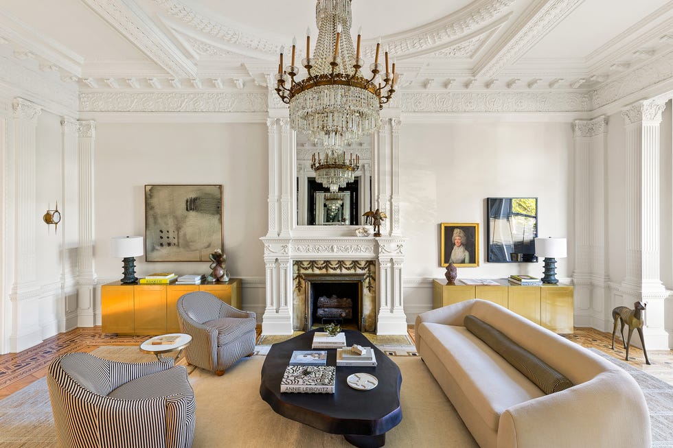 Elegant living room featuring a chandelier, fireplace, and modern furniture.