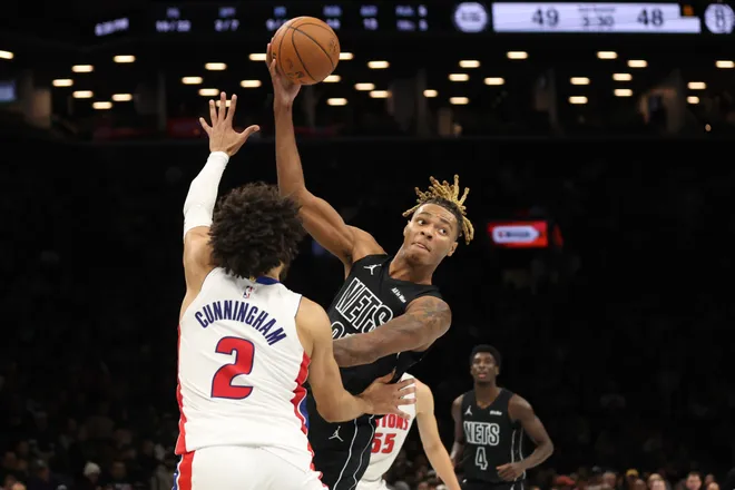 Brooklyn Nets forward Noah Clowney looks to pass the ball around Detroit Pistons guard Cade Cunningham (2) during the first half of an NBA Cup basketball game Friday, Nov. 7, 2025, in New York. (AP Photo/Heather Khalifa)