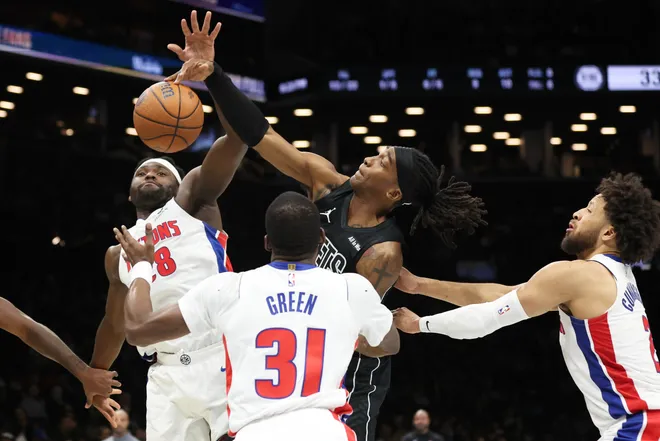 Brooklyn Nets guard Terance Mann, center, battles for a rebound with Detroit Pistons forward Isaiah Stewart, left, and Detroit Pistons guard Javonte Green (31) during the first half of an NBA Cup basketball game Friday, Nov. 7, 2025, in New York. (AP Photo/Heather Khalifa)