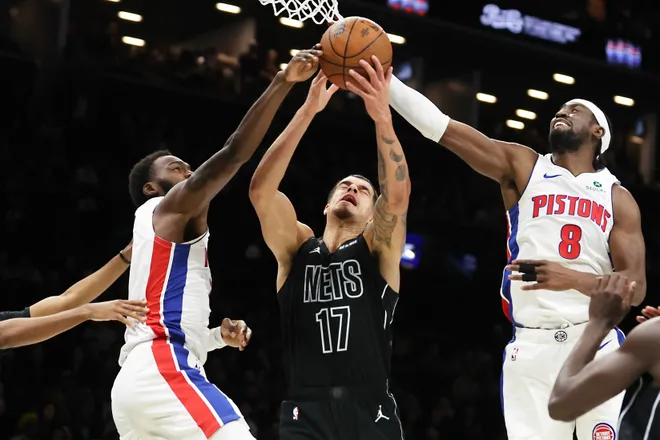 Brooklyn Nets forward Michael Porter Jr. (17) battles for a rebound with Detroit Pistons forward Paul Reed, left, and Detroit Pistons guard Caris LeVert (8) during the second half of an NBA Cup basketball game, Friday, Nov. 7, 2025, in New York. (AP Photo/Heather Khalifa)