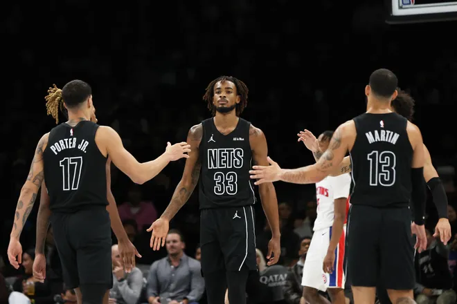 Brooklyn Nets center Nic Claxton (33) high-fives teammates during the second half of an NBA Cup basketball game against the Detroit Pistons, Friday, Nov. 7, 2025, in New York. (AP Photo/Heather Khalifa)