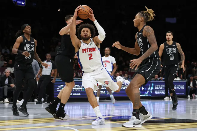 Detroit Pistons guard Cade Cunningham (2) drives to the basket past Brooklyn Nets defenders during the second half of an NBA Cup basketball game, Friday, Nov. 7, 2025, in New York. (AP Photo/Heather Khalifa)