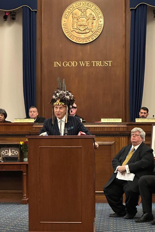 Justice Mark Montour wears a headdress inside a courtroom as he opens a ceremony to posthumously admit Seneca leader and Civil War General Ely Samuel Parker to the New York state bar on Friday, Nov. 14, 2025 in Buffalo, N.Y. (AP Photo/Carolyn Thompson)