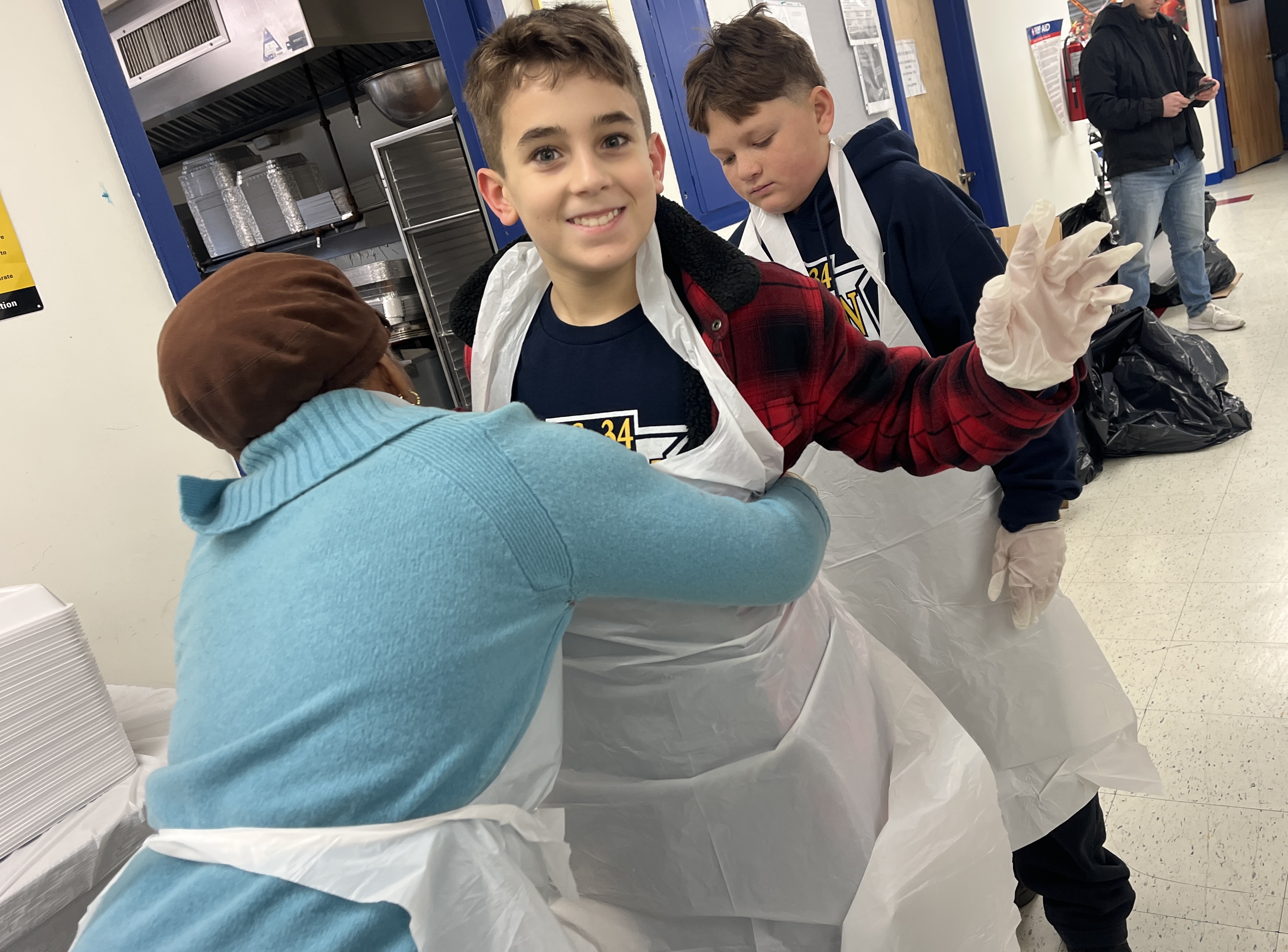 Quentin Auburn, a volunteer 7th grader from I.S. 34 is getting ready to serve lunch at Project Hospitality kitchen.  (Advance/SILive.com | Jan Somma-Hammel)