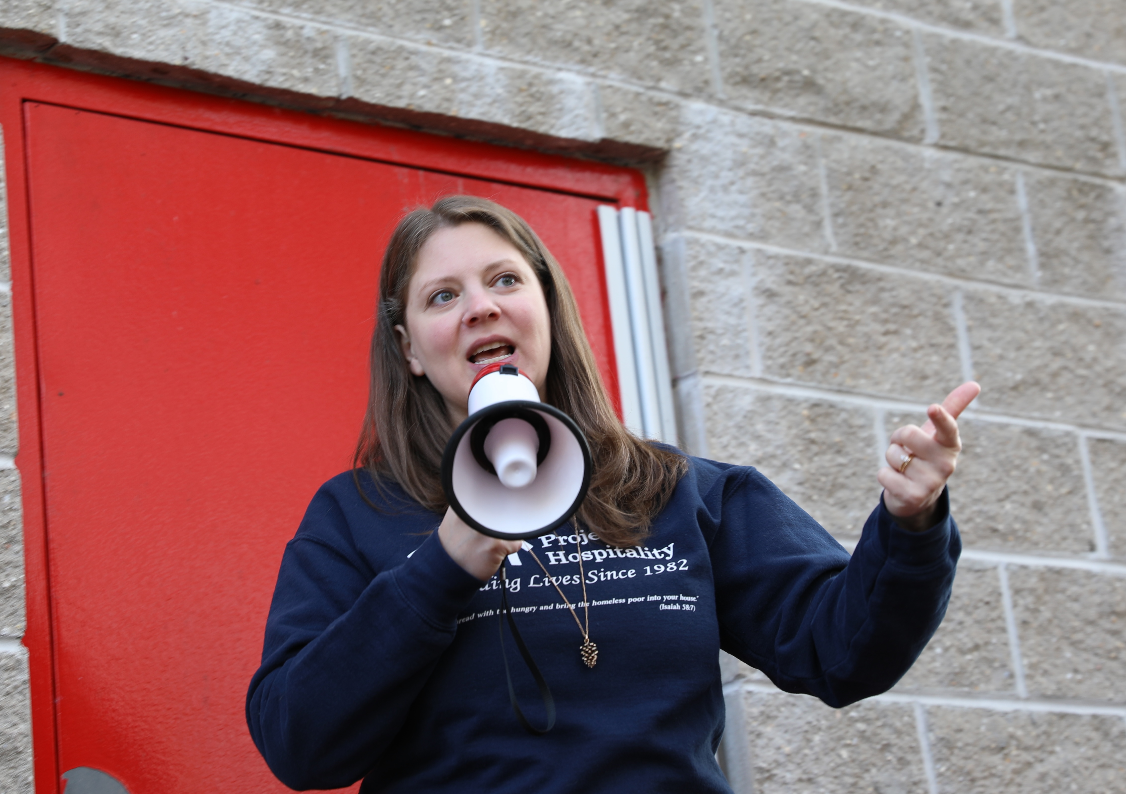 Rev. Karen Pershing, community impact officer at Project Hospitality, speaks to student volunteers as they help organize the food drive to help feed Staten Islanders in need. (Advance/SILive.com | Jan Somma-Hammel)