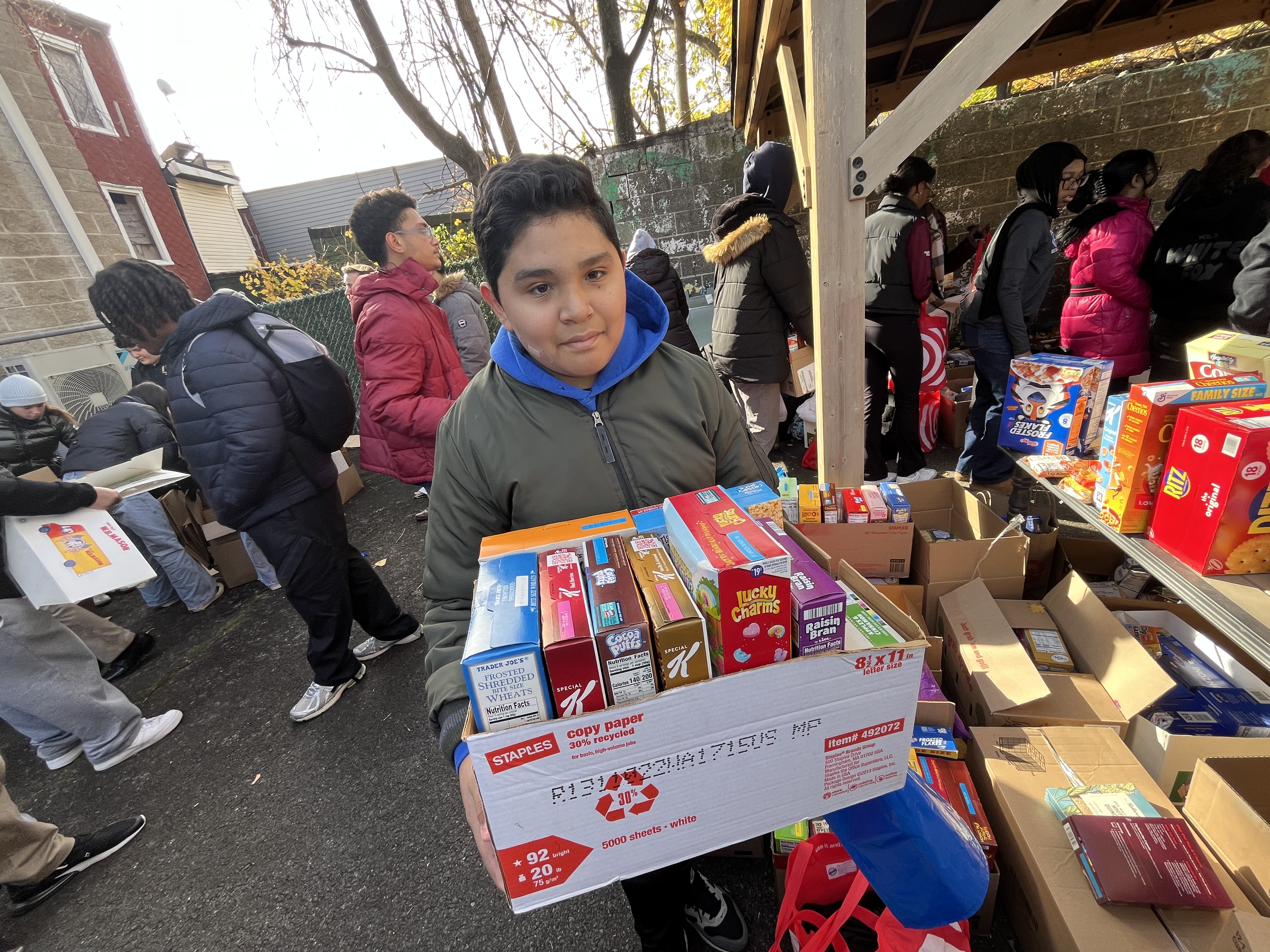Carlos Rivas Martinez a 7th grader from I.S. 51 helps organize the food drive at Project Hospitality in Stapleton  to help feed Staten Islanders in need. (Advance/SILive.com | Jan Somma-Hammel)