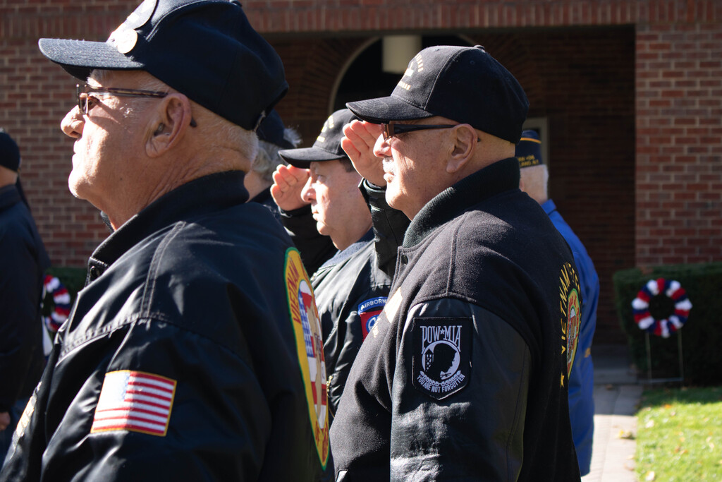 - Veterans saluting the flag during the Pledge of Allegiance. (Photo by Victoria Ifatusin)