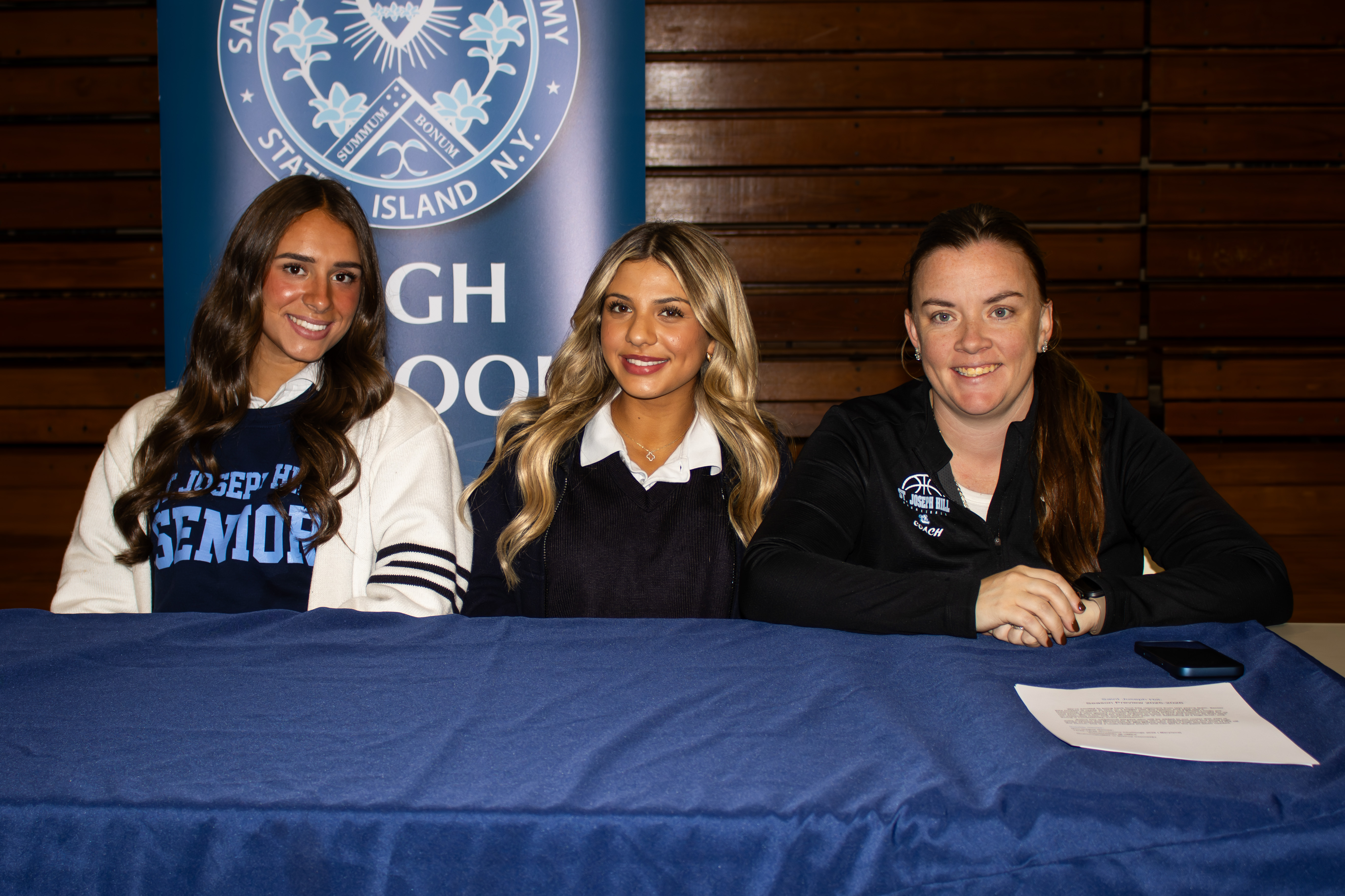 All four Staten Island CHSAA schools, alongside 26 other teams across the league, took part in the second annual event at Christ the King Monday evening. From left to right, St. Joseph Hill Academy was represented by Ella Onesto, Lauren Rodriguez and head coach Ashley Vogel. (Annie DeBiase for the Advance/SILive.com)
