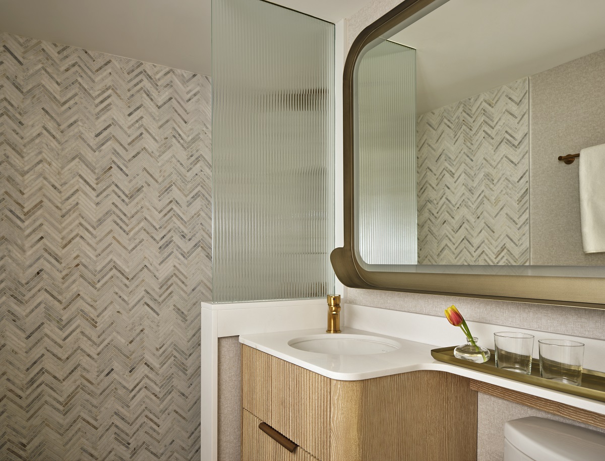tiled walls and wooden vanity in bathroom detail 