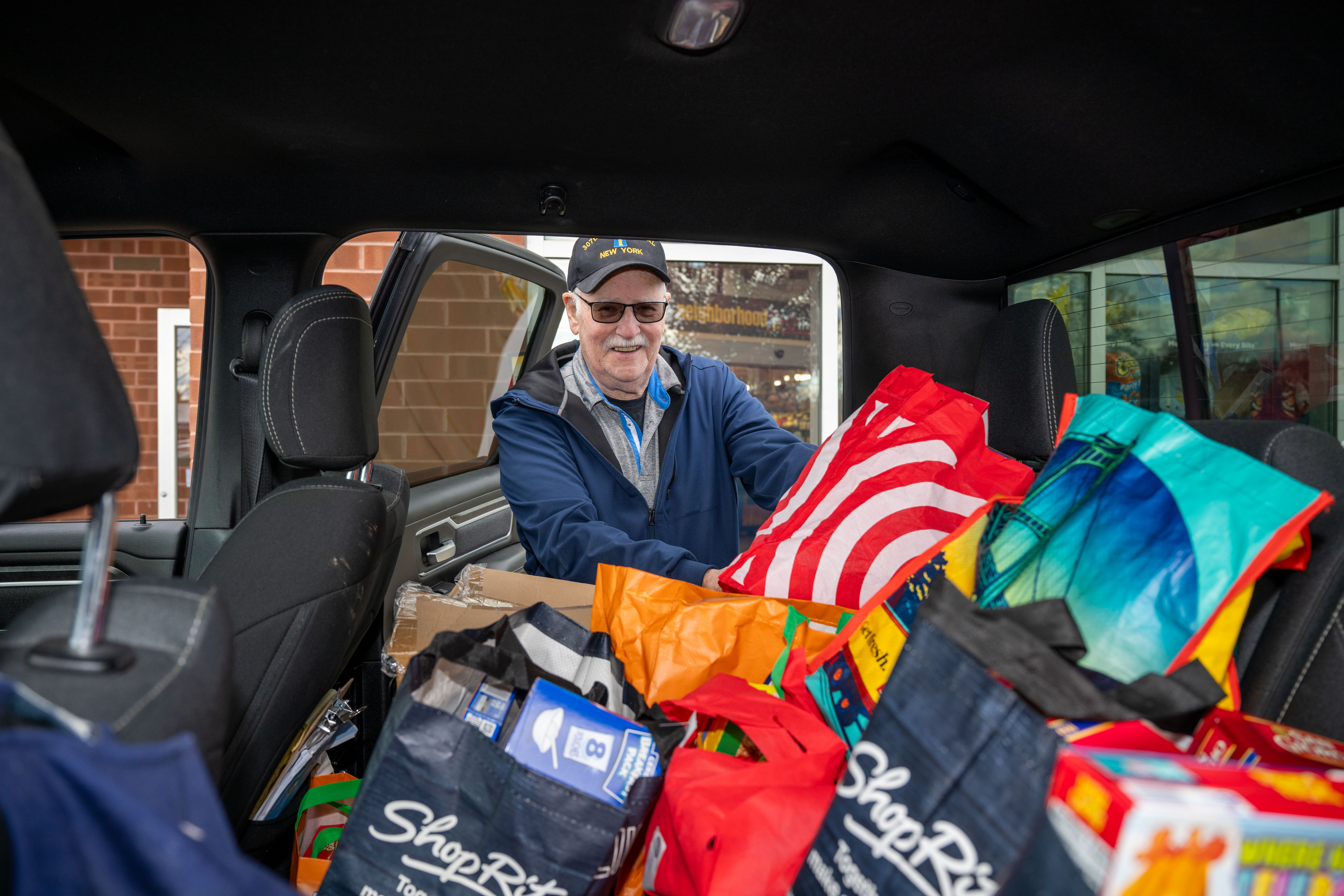 Kevin O’Connor, 83, from West Brighton, loads bags of food into a truck at the Ancient Order of Hibernians’ food drive for Blue Star Families on Saturday, November 1, 2025, in Charleston. The proceeds will benefit military families at Fort Wadsworth. (Owen Reiter for the Advance/SILive.com)