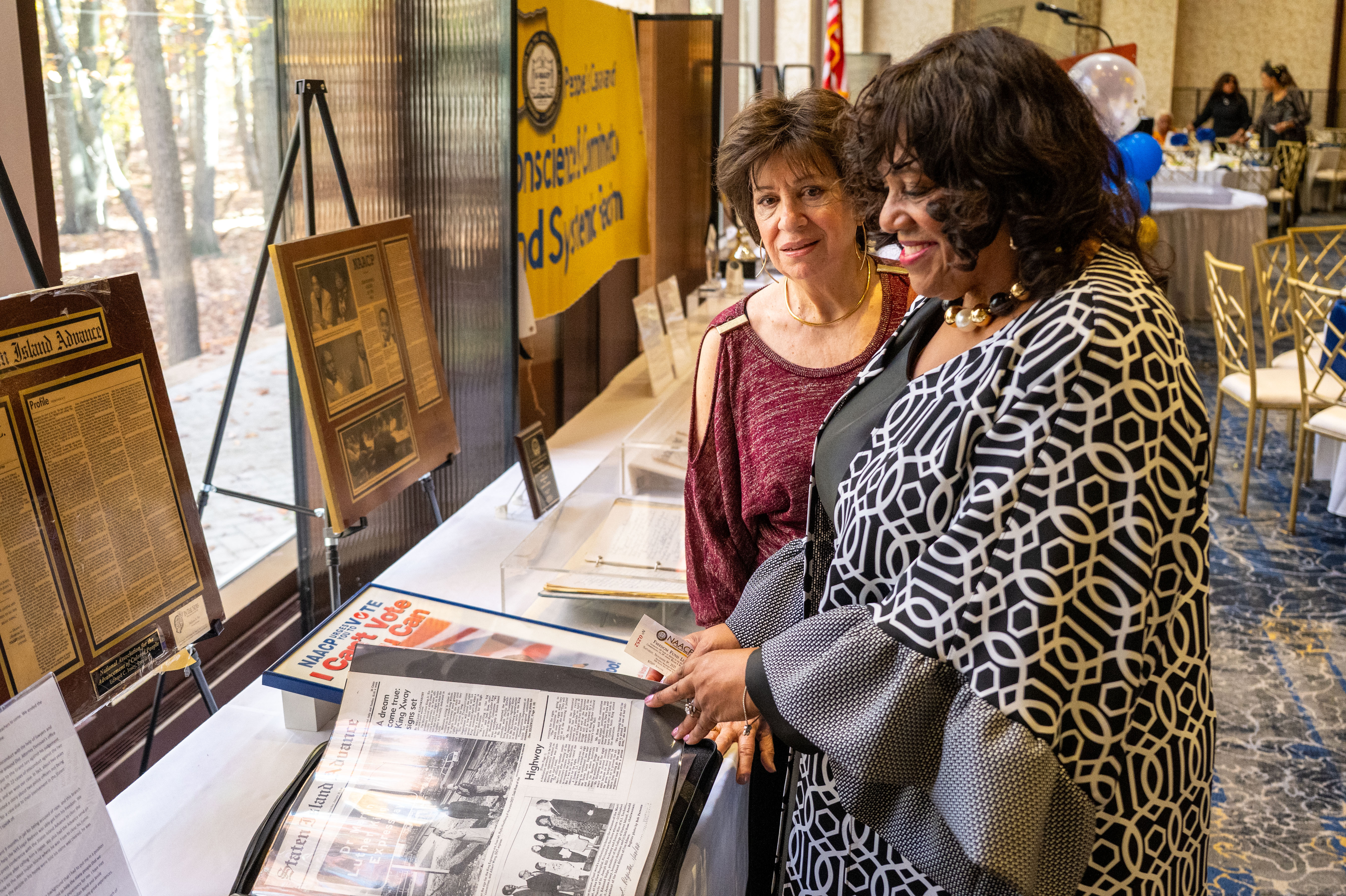 Fran Brown and former Councilmember Debi Rose check out the museum display at the Staten Island NAACP’s Freedom Fund Luncheon held at Nicotra’s Ballroom at the Hilton Garden Inn on Saturday, November 8, 2025, in Bloomfield. The milestone event marked 100 years of service to the community. (Owen Reiter for the Advance/SILive.com