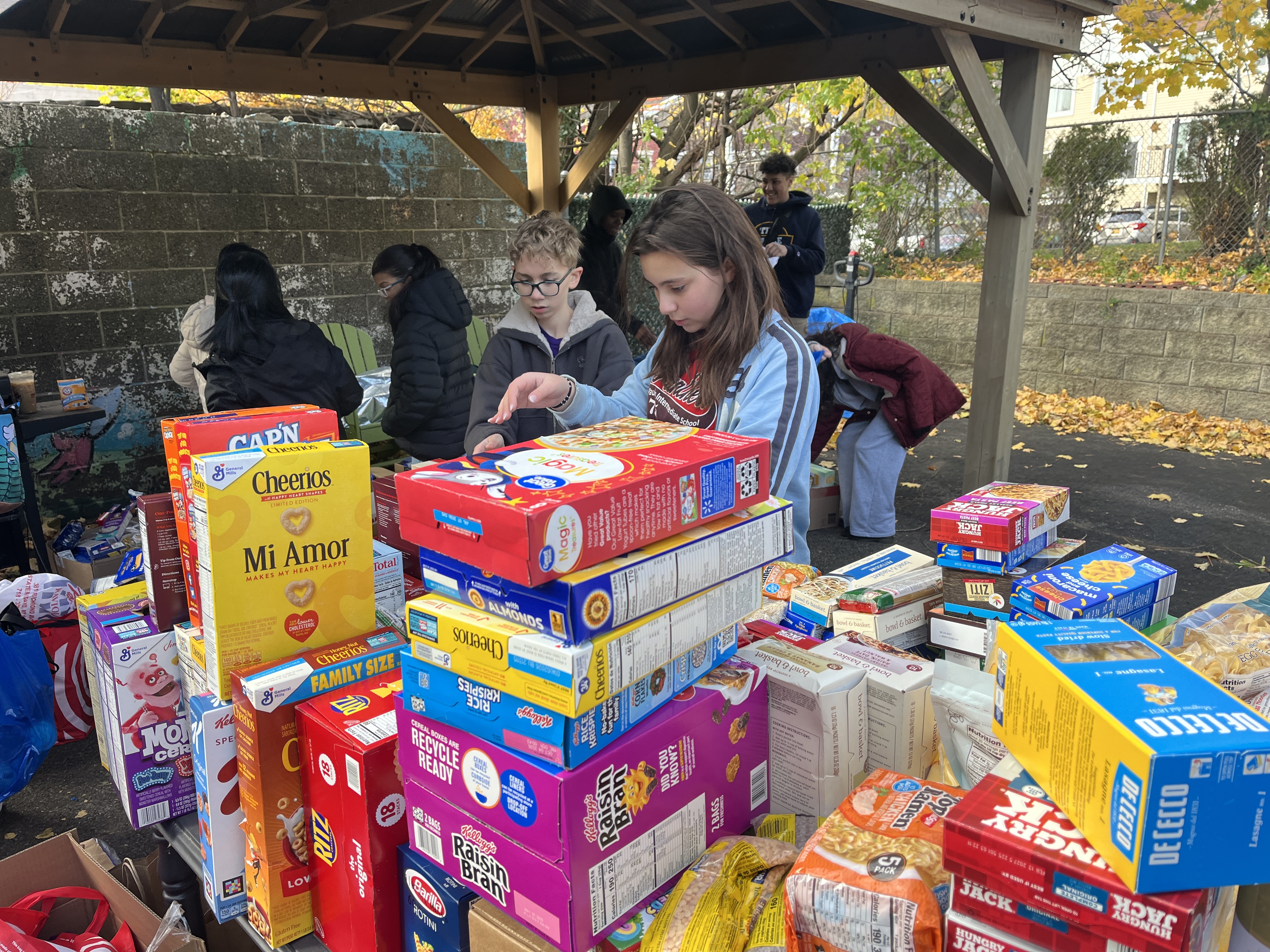Students volunteer their time ahead of the annual Project Hospitality Poor People's Dinner, which is on Monday to sort food donations and feed the hungry. (Advance/SILive.com | Jan Somma-Hammel)
