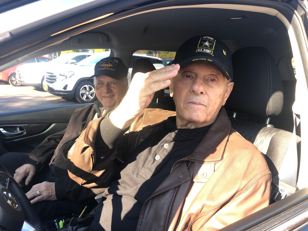 Saluting the school is veteran Frank Dell’Alba with Paul Cinquemani as the Father Capodanno Catholic Academy students welcomed local veterans in a drive by car parade with boxed breakfast and a serenade by the school chorus. Wednesday,Nov. 10, 2021
