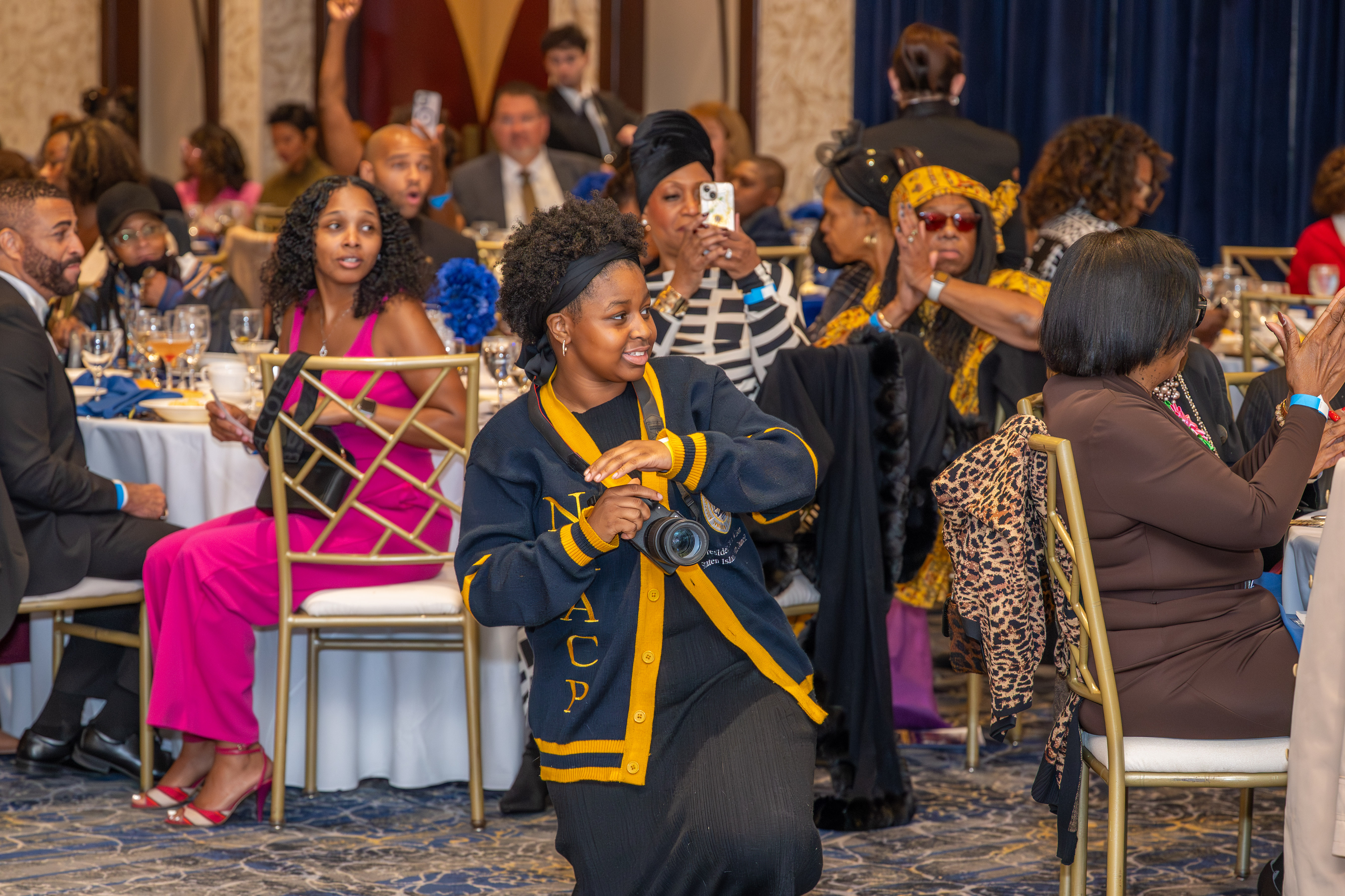 Xzayla Wilson, 16, the Staten Island Branch Youth Council President, takes photos at the Staten Island NAACP’s Freedom Fund Luncheon held at Nicotra’s Ballroom at the Hilton Garden Inn on Saturday, November 8, 2025, in Bloomfield. The milestone event marked 100 years of service to the community. (Owen Reiter for the Advance/SILive.com)