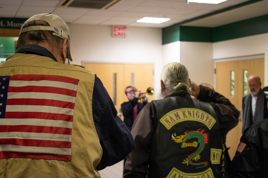 Veterans saluting to "Taps," a military song played on the trumpet by Kevin Noone, a sophomore of Wagner College. (Photo by Victoria Ifatusin)