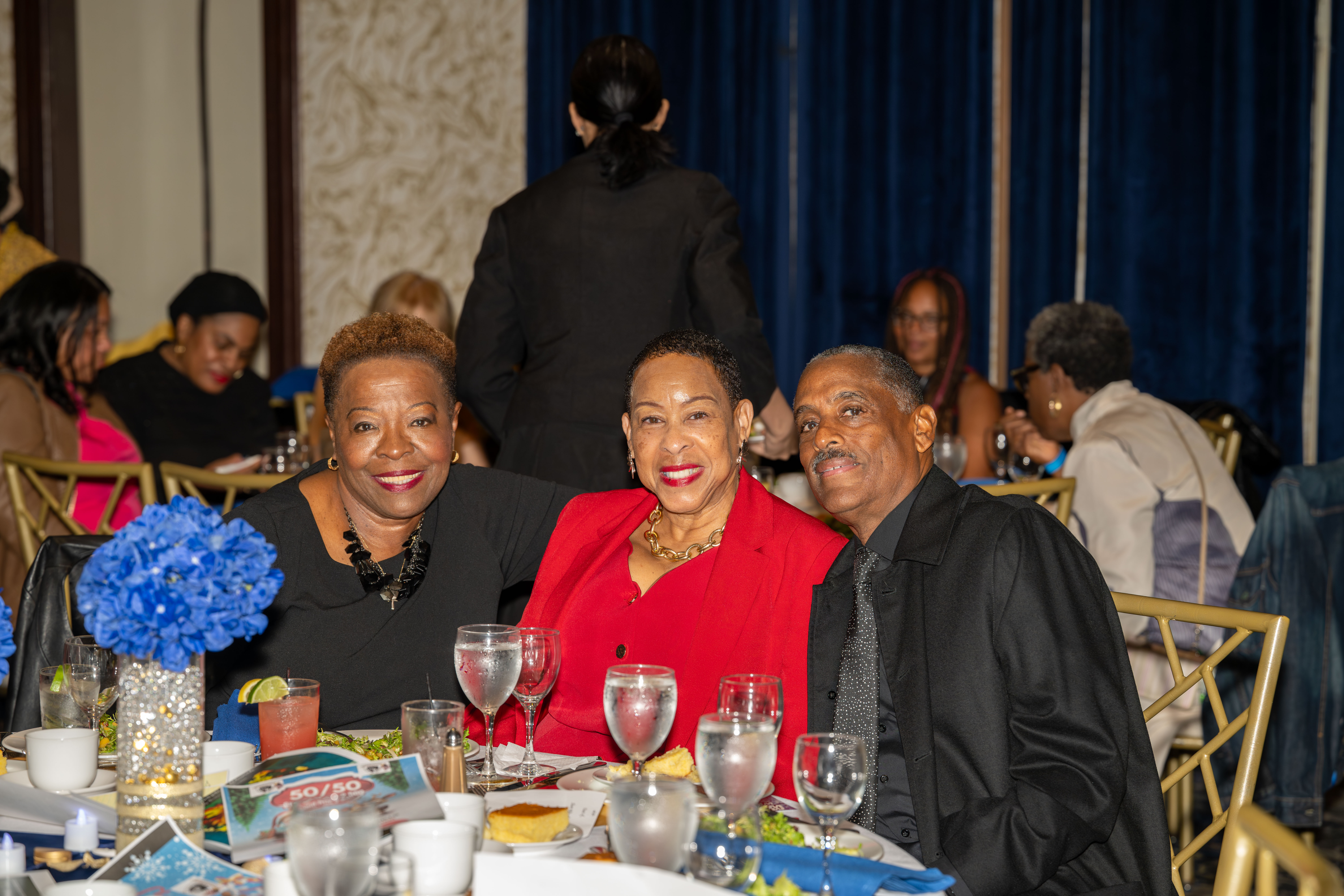 Minnie Graham, a 2024 Staten Island Advance Woman of Achievement (wearing a red dress), poses with friends at the Staten Island NAACP’s Freedom Fund Luncheon held at Nicotra’s Ballroom at the Hilton Garden Inn on Saturday, November 8, 2025, in Bloomfield. The milestone event marked 100 years of service to the community. (Owen Reiter for the Advance/SILive.com)
