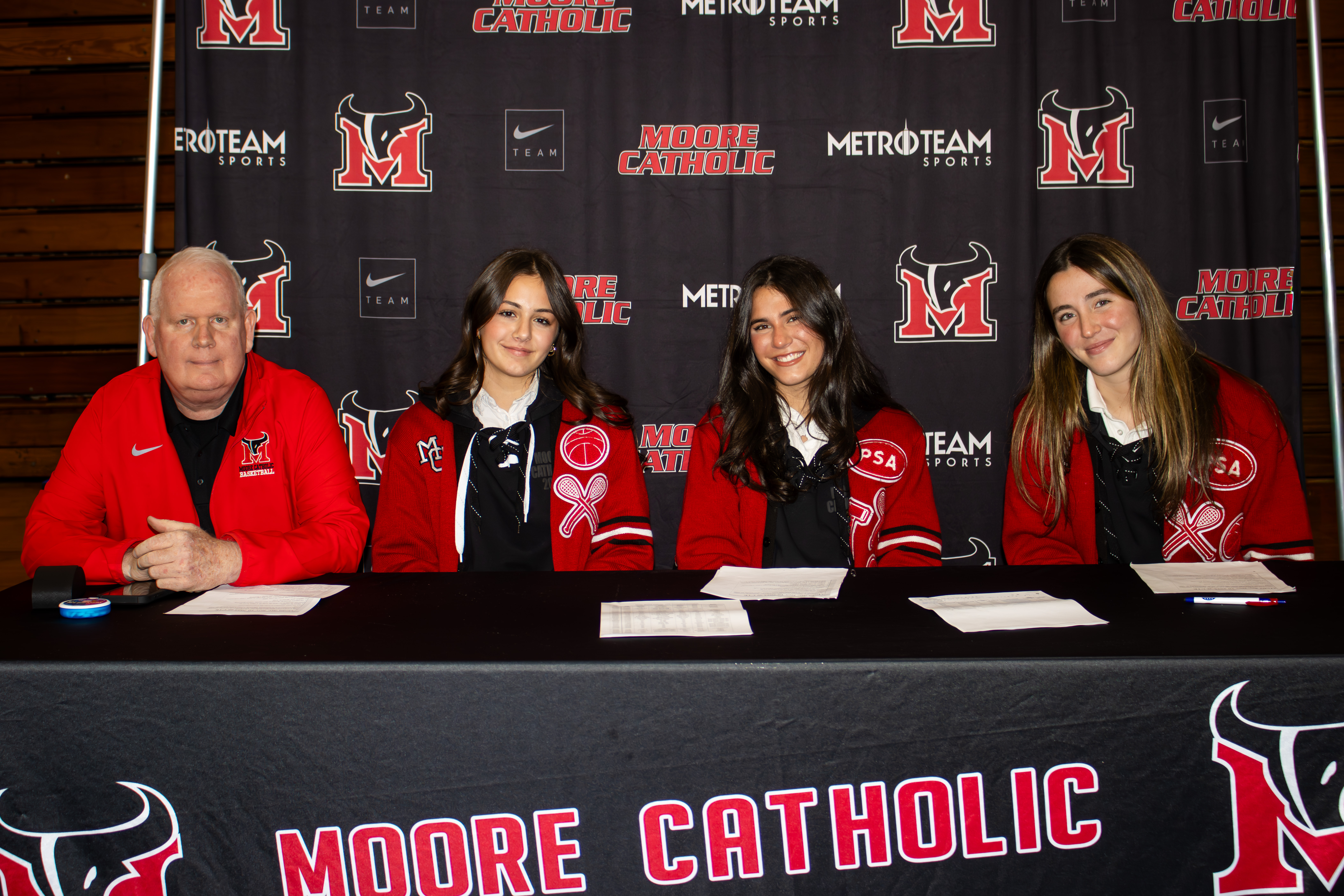 All four Staten Island CHSAA schools, alongside 26 other teams across the league, took part in the second annual event at Christ the King Monday evening. From left to right, Moore Catholic was represented by head coach Gene Henderson, Emma Costanzo, Allie Felci and Mackenzie Felci. (Annie DeBiase for the Advance/SILive.com)