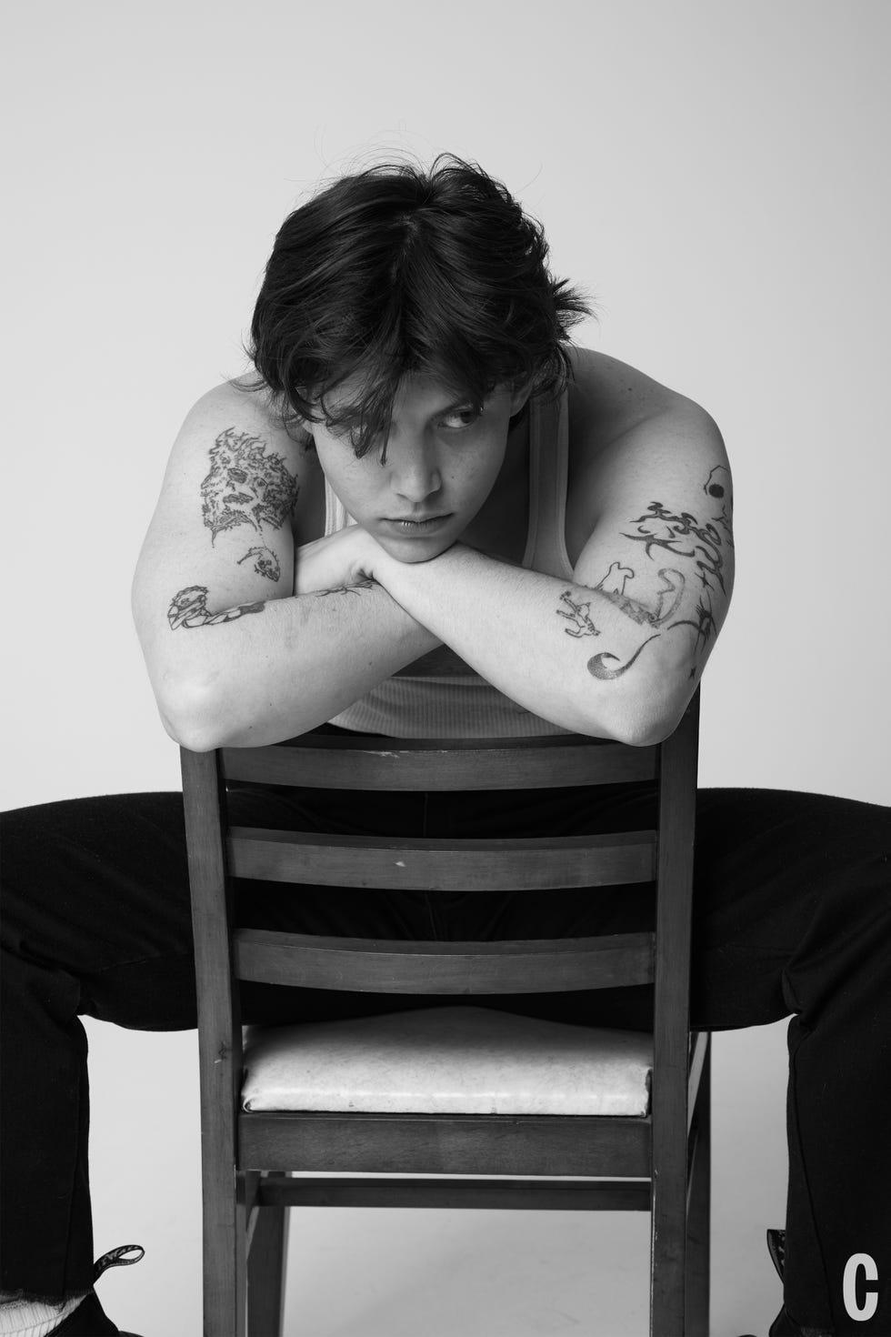 chef sitting in chair leaning over back