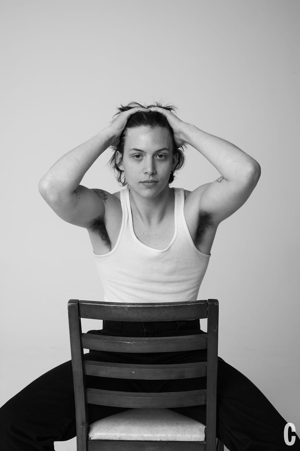 chef sitting in chair with hands on head