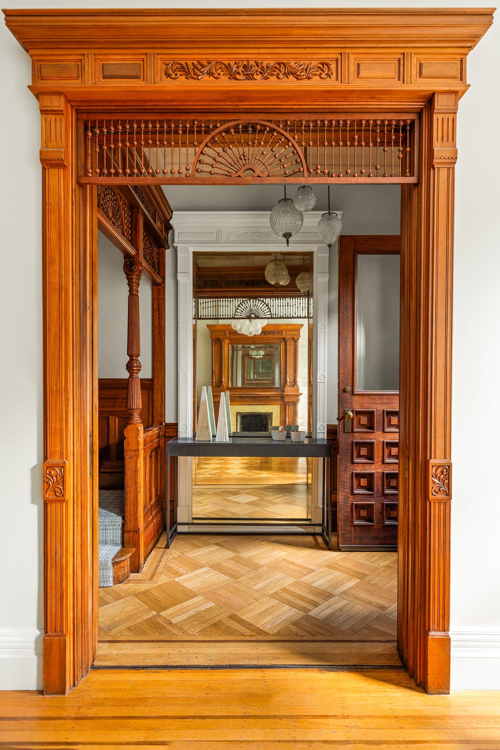 Interior doorway showcasing intricate woodwork and an inviting hallway.