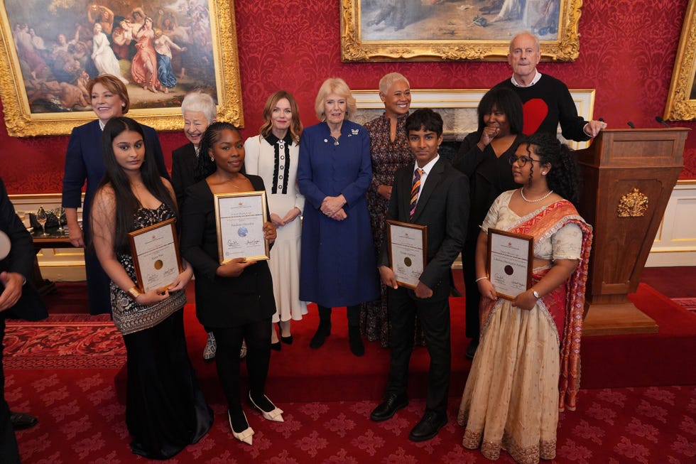london, england november 20: queen camilla (centre) stands with guests and the winners and runners up of the queen's commonwealth essay competition 2025 (l r) senior winner, kaira puri, 17, from gurugram, haryana, india, senior runner up, pandora onyedire, 17, from lagos, nigeria, junior winner, vivian agarwal, 14, of mumbai, india and junior runner up, lakshmi manognya achanta, 14, from singapore, during a reception at st james's palace on november 20, 2025 in london, england. (photo by yui mok wpa pool/getty images)