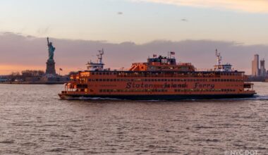 Image of the Staten Island Ferry ‘Spirit of America’ making a trip during sunset.