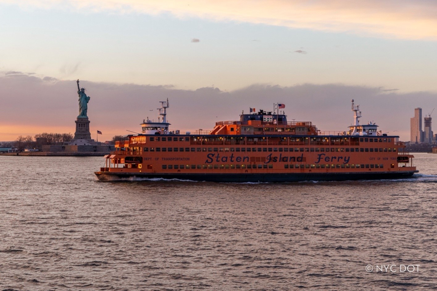 Image of the Staten Island Ferry ‘Spirit of America’ making a trip during sunset.