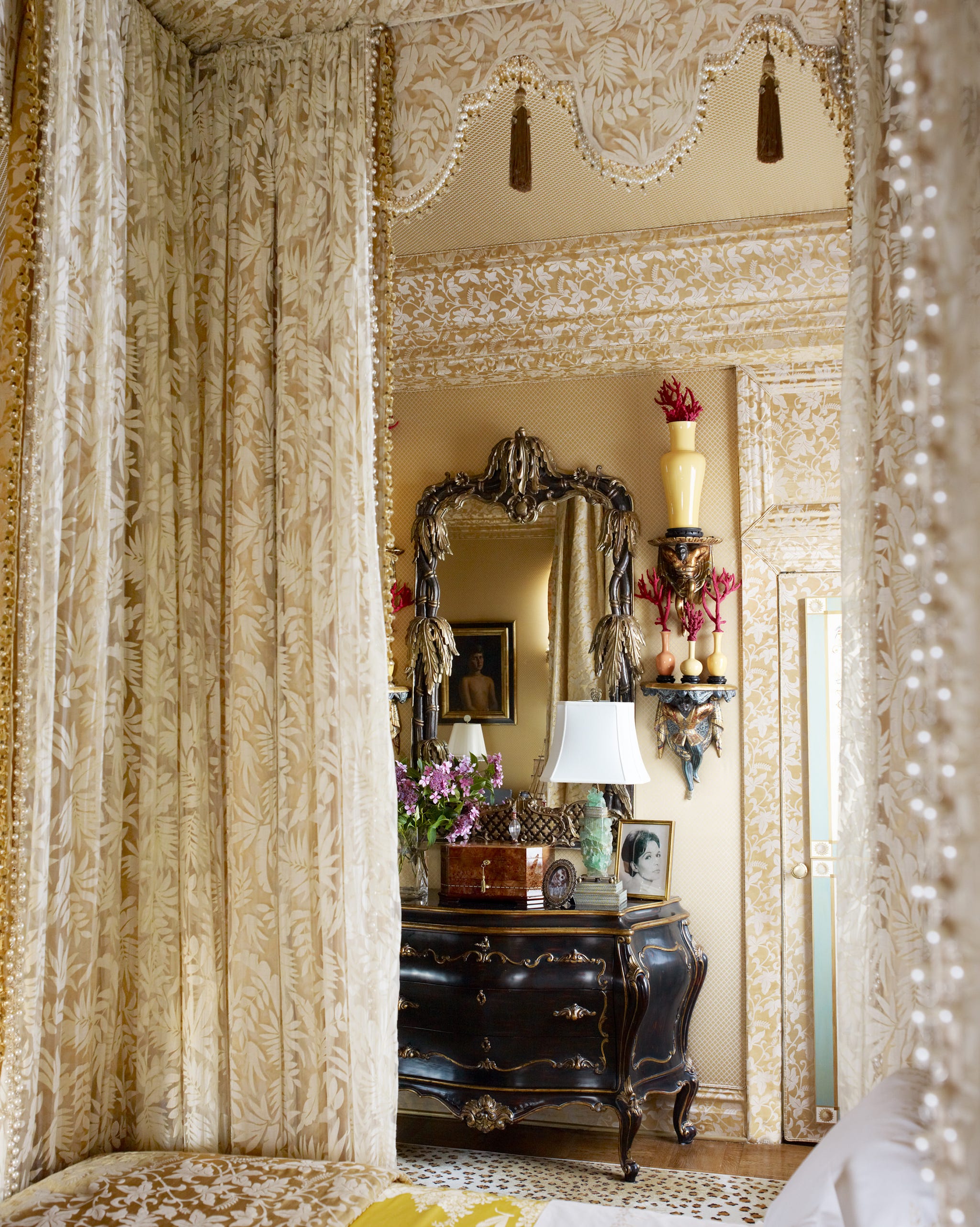 primary bedroom detail looking through the bed towards armoire and mirror