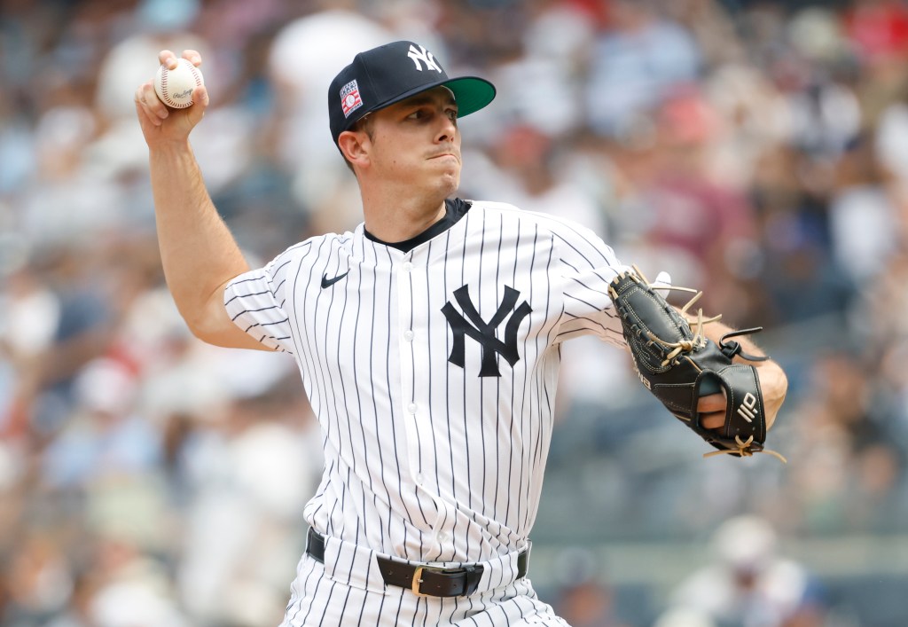 Allan Winans pitching in a New York Yankees uniform during the 7th inning.