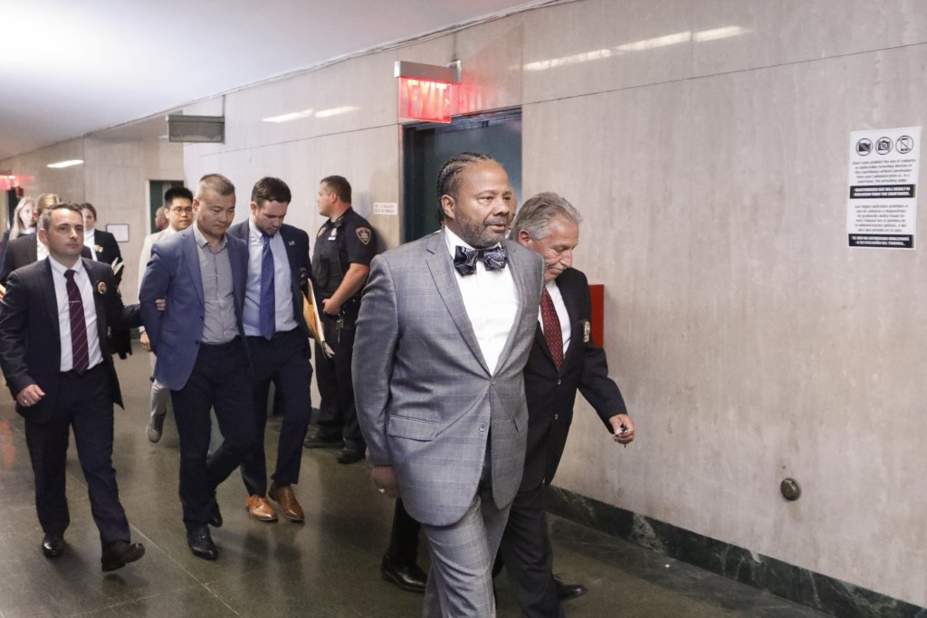 Department of Citywide Administrative Services Deputy Commissioner Jesse Hamilton is escorted into Manhattan Criminal Court to be arraigned on corruption charges.