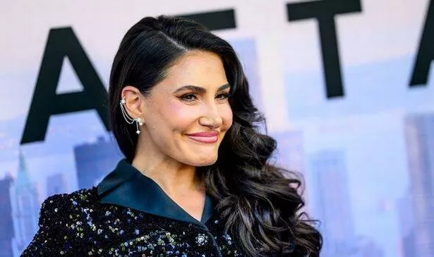 A woman with dark hair smiles