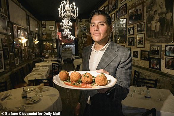 Vitolo seen holding a plate of arancini