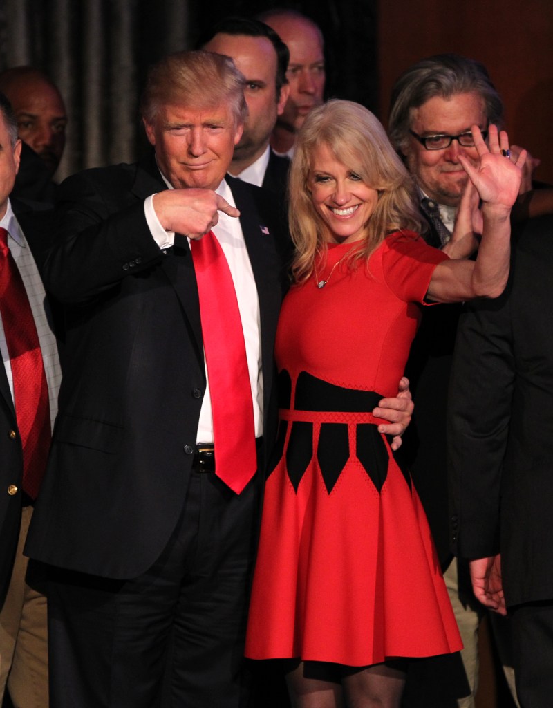 Donald Trump pointing to Kellyanne Conway, who is smiling and waving, at the New York Hilton Election Night party.