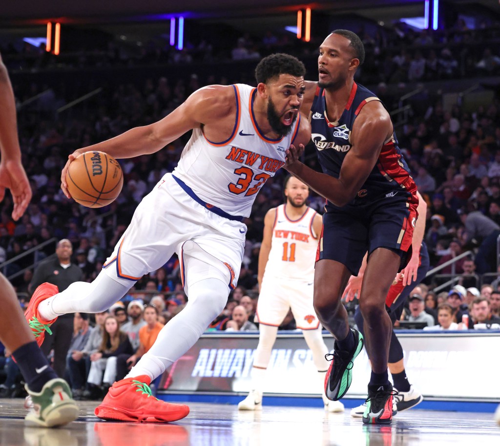 New York Knicks center Karl-Anthony Towns #32 drives down court as Cleveland Cavaliers center Evan Mobley #4 defends during the second quarter.