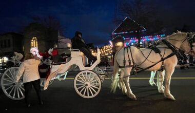 Santa rides down Forest Avenue for the the 2025 stroll through West Brighton
