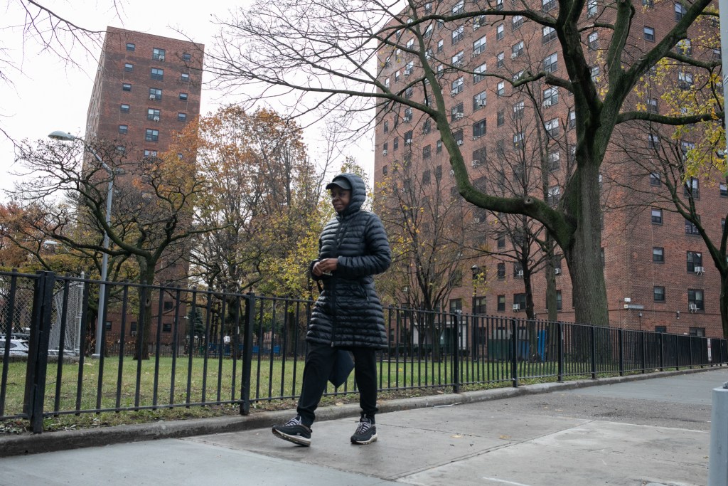 A woman walks past the Boulevard Houses complex in East New York.